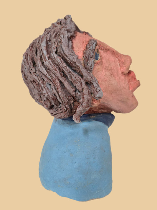 Side view of a an sculpture with grey hair.